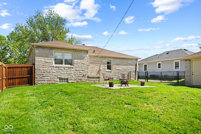 909 E Markwood Ave, Indianapolis, IN 46227 - rear view of property featuring stone siding, a patio, a gate, and a shingled roof