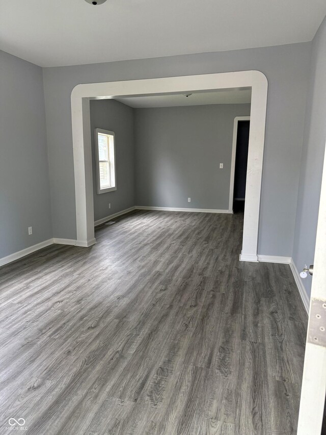 23 S Holmes Ave, Indianapolis, IN 46222 - spare room with baseboards and dark wood-type flooring