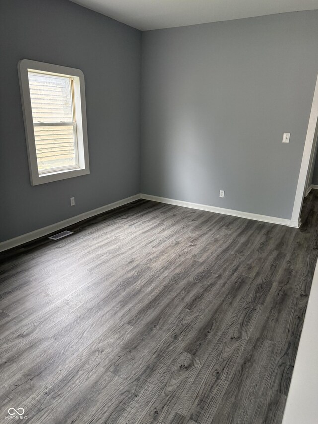 23 S Holmes Ave, Indianapolis, IN 46222 - empty room featuring dark wood-style floors and baseboards