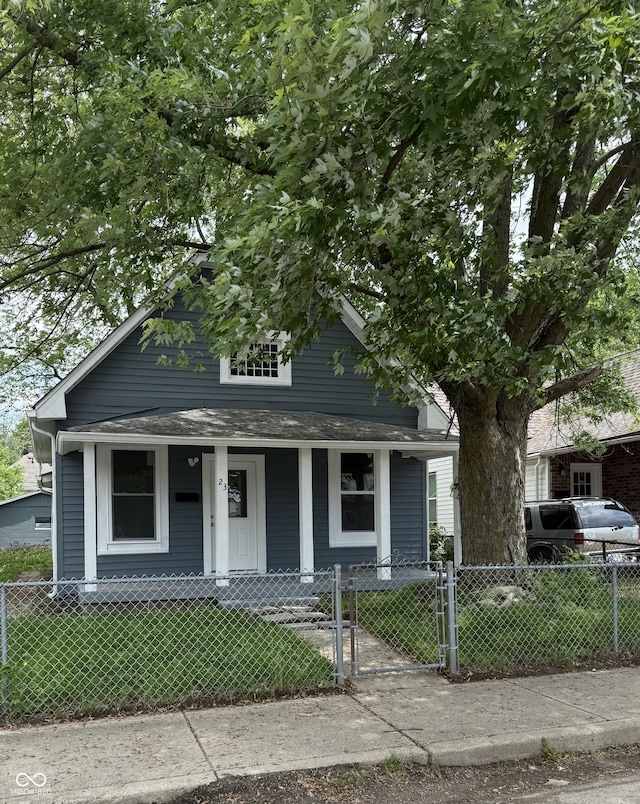 23 S Holmes Ave, Indianapolis, IN 46222 - shotgun-style home featuring covered porch