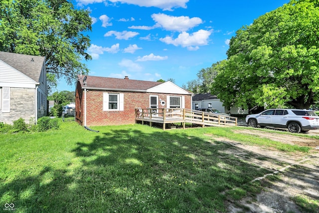 3310 Ransdell St, Indianapolis, IN 46227 - back of property featuring brick siding, a deck, a lawn, and a chimney