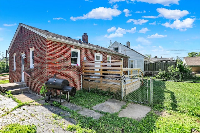 3310 Ransdell St, Indianapolis, IN 46227 - back of house featuring a chimney, a gate, and brick siding