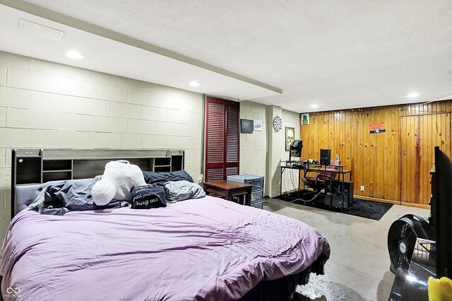 3310 Ransdell St, Indianapolis, IN 46227 - bedroom featuring concrete flooring, concrete block wall, and wood walls
