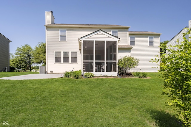 14135 Nicholas Dr, Carmel, IN 46074 - back of house with a sunroom, a lawn, and a chimney