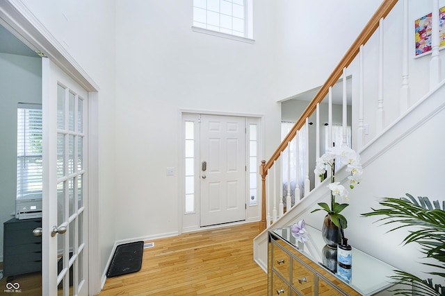 14135 Nicholas Dr, Carmel, IN 46074 - entryway with light wood finished floors, stairs, a high ceiling, and baseboards