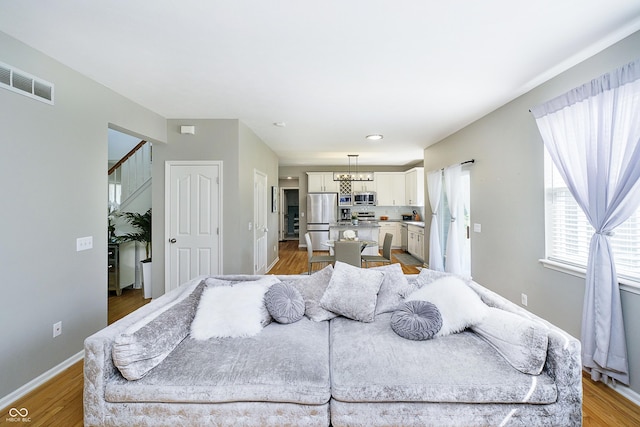 14135 Nicholas Dr, Carmel, IN 46074 - living area with a chandelier, light wood-type flooring, and baseboards