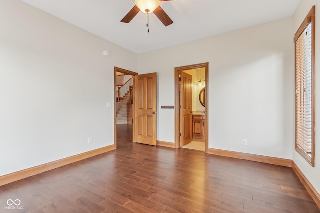2825 S State Road 267, Plainfield, IN 46168 - unfurnished bedroom with baseboards, wood finished floors, connected bathroom, and ceiling fan
