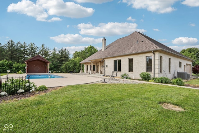2825 S State Road 267, Plainfield, IN 46168 - rear view of property featuring central AC unit, a chimney, a patio, an outdoor pool, and roof with shingles