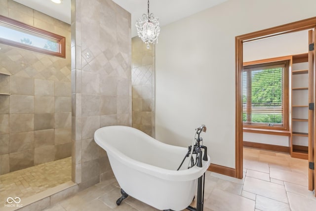 2825 S State Road 267, Plainfield, IN 46168 - full bathroom featuring a freestanding tub, a chandelier, a walk in shower, and baseboards