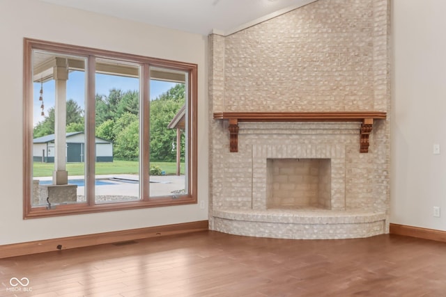 2825 S State Road 267, Plainfield, IN 46168 - unfurnished living room with baseboards, wood finished floors, and a brick fireplace