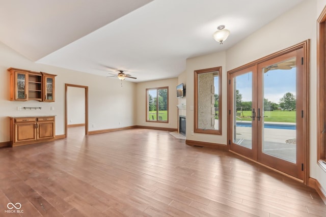 2825 S State Road 267, Plainfield, IN 46168 - unfurnished living room featuring french doors, light wood-style flooring, and baseboards