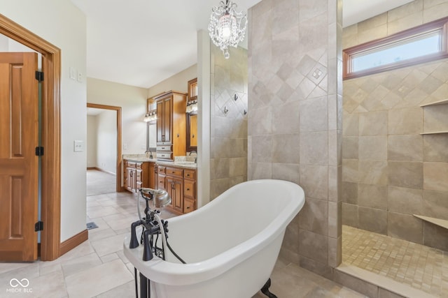 2825 S State Road 267, Plainfield, IN 46168 - bathroom featuring a freestanding bath, double vanity, a walk in shower, tile patterned floors, and a chandelier