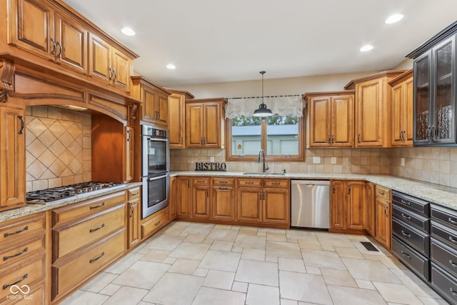 2825 S State Road 267, Plainfield, IN 46168 - kitchen with stainless steel appliances, a sink, brown cabinets, light stone countertops, and decorative backsplash