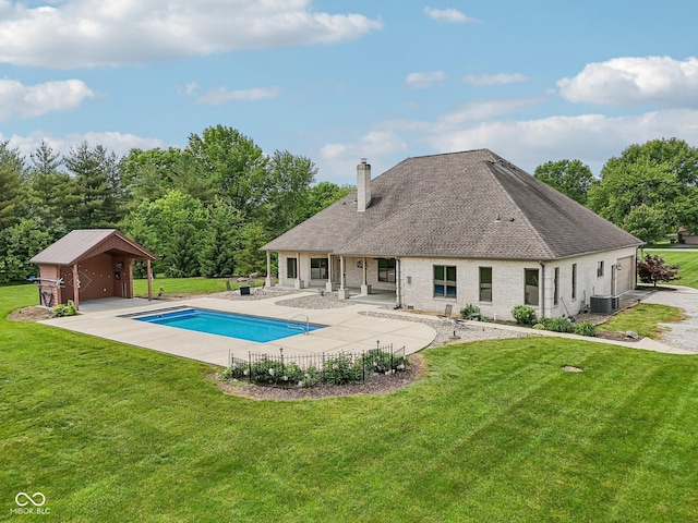 2825 S State Road 267, Plainfield, IN 46168 - rear view of house featuring a chimney, a patio area, an outdoor pool, a yard, and roof with shingles