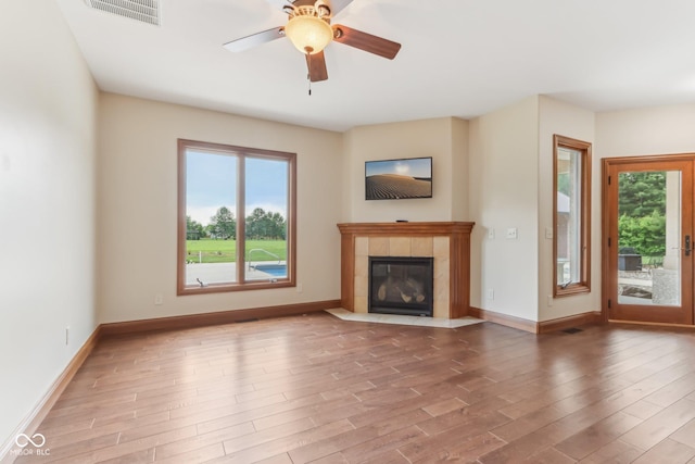 2825 S State Road 267, Plainfield, IN 46168 - unfurnished living room featuring plenty of natural light, wood finished floors, a tile fireplace, and baseboards