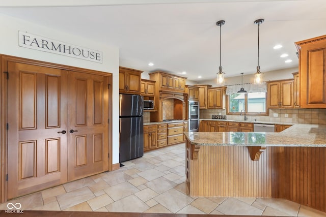 2825 S State Road 267, Plainfield, IN 46168 - kitchen featuring appliances with stainless steel finishes, a peninsula, brown cabinets, a sink, and tasteful backsplash