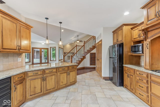 2825 S State Road 267, Plainfield, IN 46168 - kitchen with freestanding refrigerator, stainless steel microwave, brown cabinets, lofted ceiling, and recessed lighting