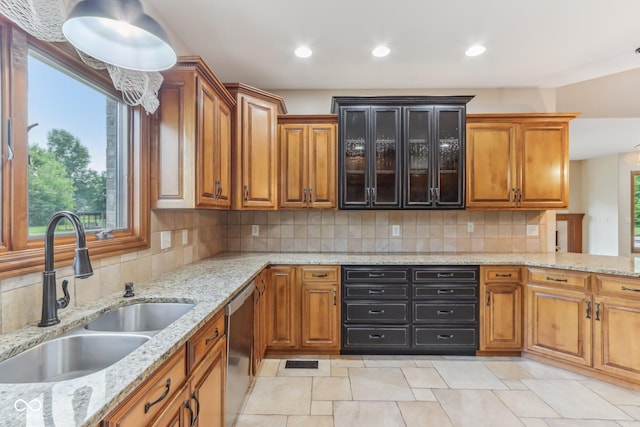 2825 S State Road 267, Plainfield, IN 46168 - kitchen featuring a sink, stainless steel dishwasher, brown cabinetry, glass insert cabinets, and decorative backsplash