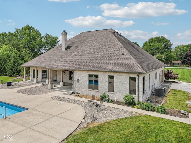 2825 S State Road 267, Plainfield, IN 46168 - back of house with a chimney, central AC, roof with shingles, a patio area, and an outdoor pool