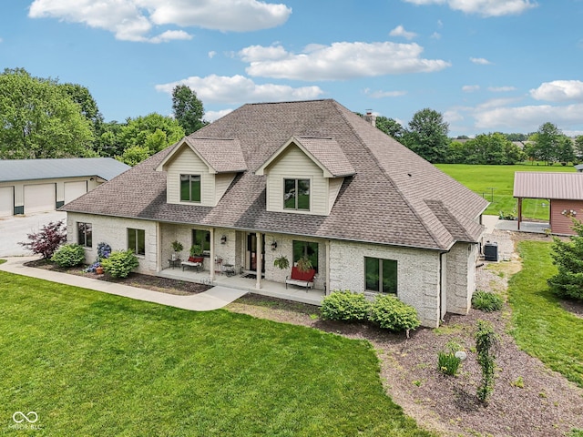 2825 S State Road 267, Plainfield, IN 46168 - view of front of house with roof with shingles, a front lawn, brick siding, a detached garage, and an outbuilding