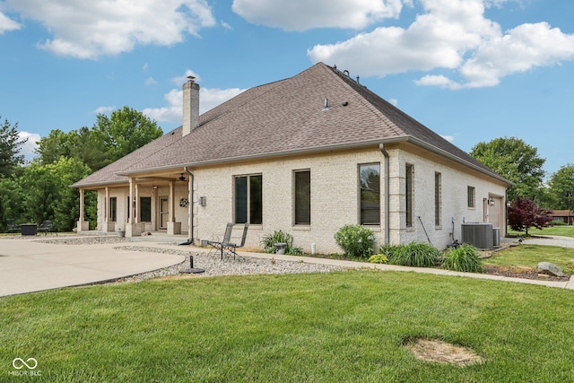 2825 S State Road 267, Plainfield, IN 46168 - rear view of property with central AC, a chimney, a lawn, a patio area, and roof with shingles