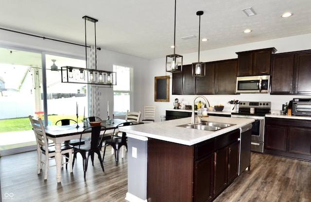 1880 Explorer Ct, Franklin, IN 46131 - kitchen featuring stainless steel appliances, a sink, light countertops, dark wood-type flooring, and recessed lighting