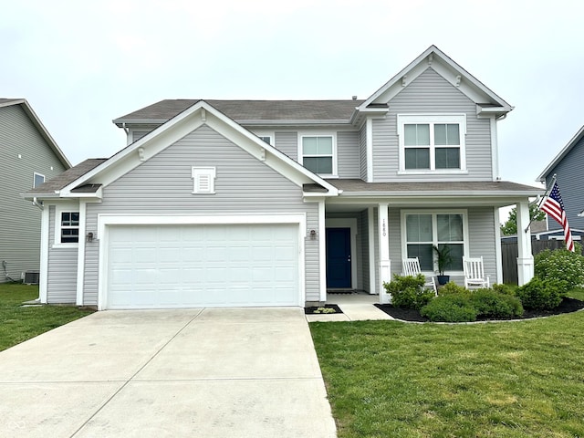1880 Explorer Ct, Franklin, IN 46131 - traditional-style house with covered porch, driveway, a front lawn, and an attached garage