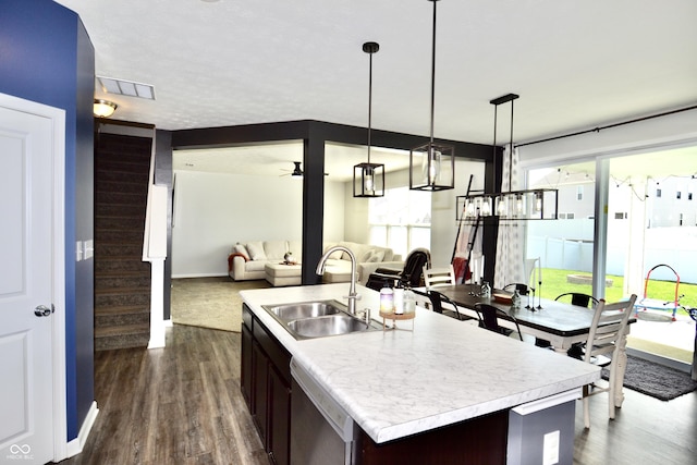 1880 Explorer Ct, Franklin, IN 46131 - kitchen with stainless steel dishwasher, open floor plan, light countertops, dark wood-style flooring, and a sink