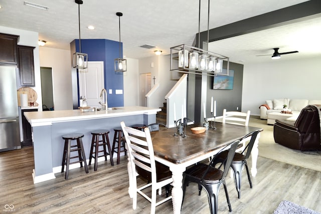 1880 Explorer Ct, Franklin, IN 46131 - dining room featuring light wood-type flooring, a ceiling fan, and baseboards