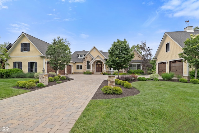 860 Chatham Hills Blvd, Westfield, IN 46074 - view of front facade featuring decorative driveway, a front yard, a garage, and stone siding
