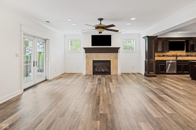860 Chatham Hills Blvd, Westfield, IN 46074 - unfurnished living room featuring plenty of natural light, a fireplace, light wood-style flooring, crown molding, and baseboards