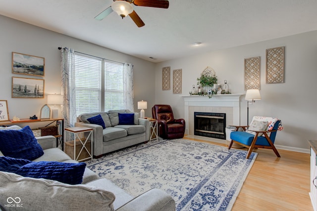 7452 Lace Bark Ct, Avon, IN 46123 - living room with a fireplace, light wood-style flooring, ceiling fan, and baseboards