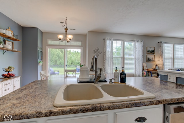 7452 Lace Bark Ct, Avon, IN 46123 - kitchen with a sink, healthy amount of natural light, dark countertops, and white cabinets