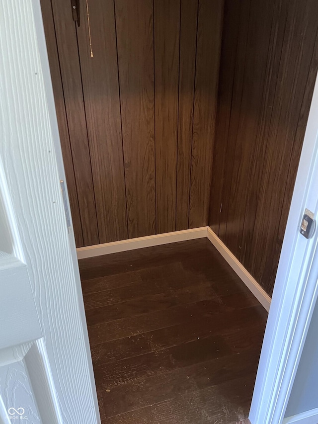 261 S Main St, Marshall, IN 47859 - unfurnished room featuring dark wood-type flooring, baseboards, and wood walls