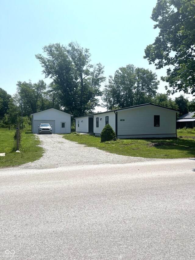 261 S Main St, Marshall, IN 47859 - manufactured / mobile home featuring a garage, an outdoor structure, and driveway