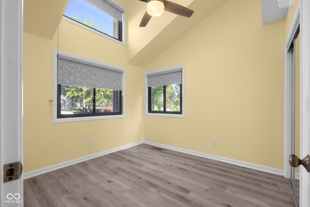 740 Carya Sq, Columbus, IN 47201 - unfurnished bedroom featuring wood finished floors, baseboards, a high ceiling, and a ceiling fan