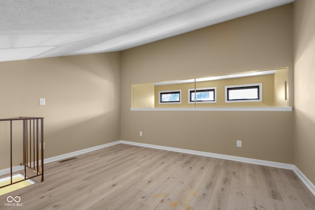 740 Carya Sq, Columbus, IN 47201 - spare room with wood finished floors, baseboards, and a textured ceiling