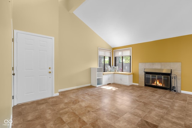 740 Carya Sq, Columbus, IN 47201 - unfurnished living room featuring high vaulted ceiling, a tiled fireplace, and baseboards
