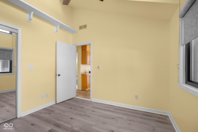 740 Carya Sq, Columbus, IN 47201 - unfurnished bedroom with light wood-style floors, high vaulted ceiling, and baseboards