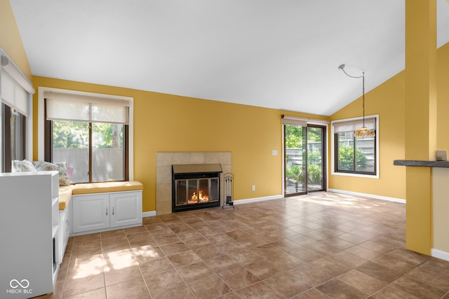 740 Carya Sq, Columbus, IN 47201 - unfurnished living room featuring a tile fireplace, lofted ceiling, and baseboards
