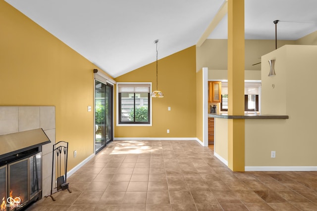 740 Carya Sq, Columbus, IN 47201 - unfurnished living room featuring vaulted ceiling, baseboards, and tile patterned flooring