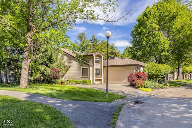 740 Carya Sq, Columbus, IN 47201 - view of front facade with concrete driveway, a front yard, and an attached garage