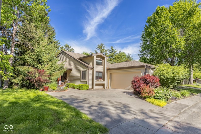 740 Carya Sq, Columbus, IN 47201 - obstructed view of property with concrete driveway, a garage, and a front yard