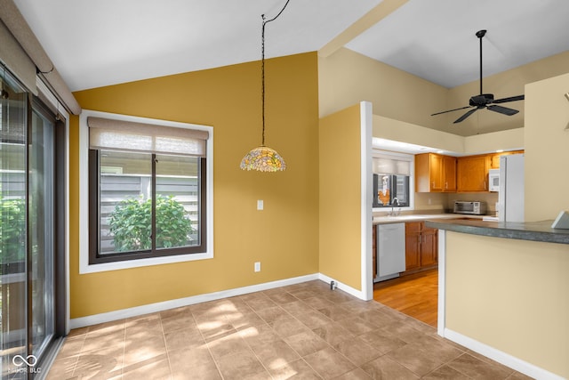 740 Carya Sq, Columbus, IN 47201 - kitchen with white appliances, brown cabinetry, high vaulted ceiling, a sink, and baseboards