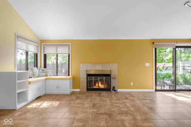 740 Carya Sq, Columbus, IN 47201 - unfurnished living room with a fireplace, lofted ceiling, light tile patterned floors, and baseboards