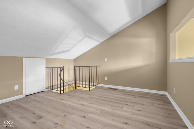 740 Carya Sq, Columbus, IN 47201 - bonus room featuring lofted ceiling, wood finished floors, and baseboards
