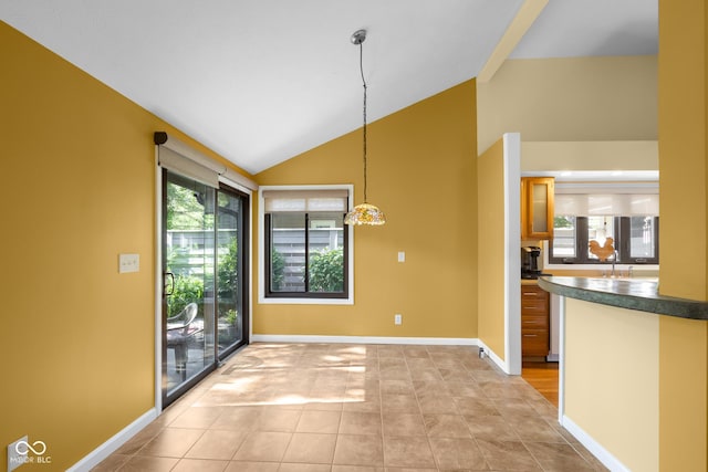 740 Carya Sq, Columbus, IN 47201 - unfurnished dining area featuring vaulted ceiling, baseboards, and light tile patterned floors