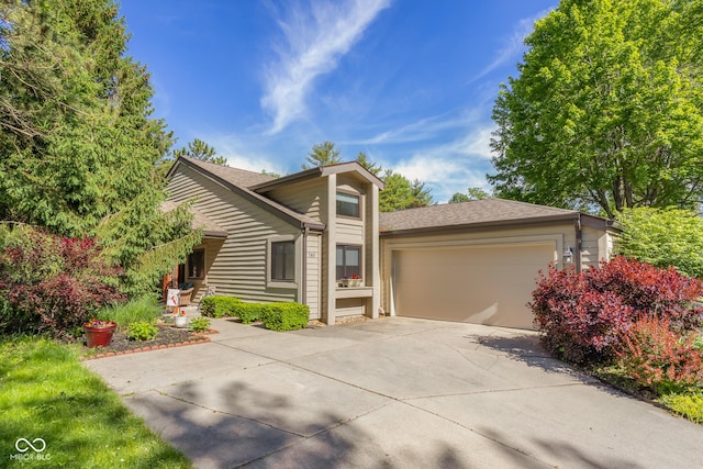 740 Carya Sq, Columbus, IN 47201 - view of front facade featuring driveway, a garage, and a shingled roof