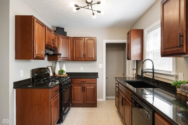 5232 E 10th St, Indianapolis, IN 46219 - kitchen featuring black appliances, a sink, under cabinet range hood, a chandelier, and dark stone counters