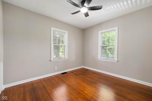 5232 E 10th St, Indianapolis, IN 46219 - unfurnished room featuring a ceiling fan, hardwood / wood-style flooring, and baseboards